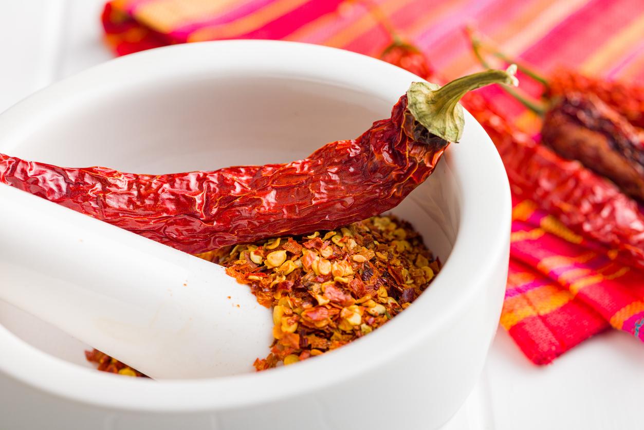 Gordo's Foodservice - Dry Chili Pepper Flakes. Crushed Red Peppers In Mortar On White Table.